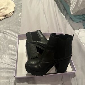 Black platform boots by Divided